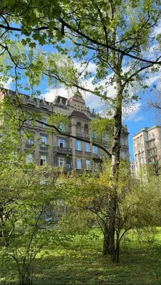 a large building in the middle of a park with trees at OLD TOWN Charm & Chic by Downtown Apartments in Kraków