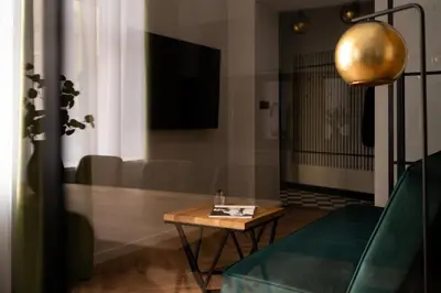a living room with a table and a couch at OLD TOWN Charm & Chic by Downtown Apartments in Kraków