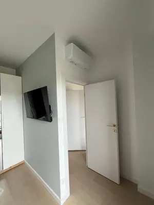 an empty room with a flat screen tv on the wall at Tropical Novum Apartment - Krakow Old Town in Kraków