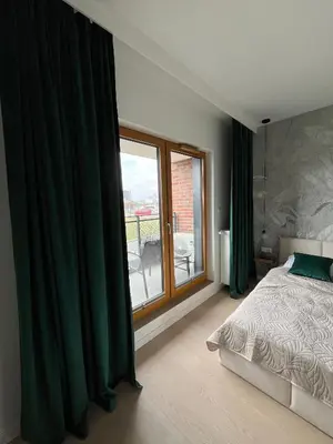 a bedroom with a bed and a large window at Tropical Novum Apartment - Krakow Old Town in Kraków