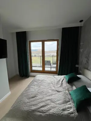 a bedroom with a large bed and a window at Tropical Novum Apartment - Krakow Old Town in Kraków