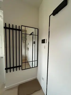 a room with a mirror on the wall at Tropical Novum Apartment - Krakow Old Town in Kraków