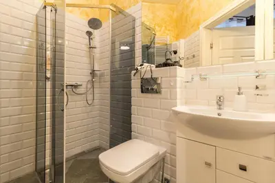 a bathroom with a toilet and a sink and a shower at Nowy Kleparz 2 in Kraków