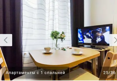 a kitchen and dining room with a table and a desk at Nowy Kleparz 2 in Kraków