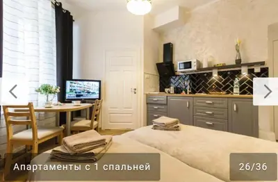 a kitchen and dining room with a table and a desk at Nowy Kleparz 2 in Kraków