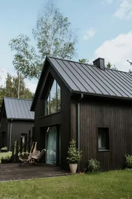 a house with a black roof at Osada Zawadka in Zawadka