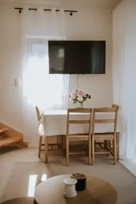 a dining room table with a vase of flowers on it at Osada Zawadka in Zawadka