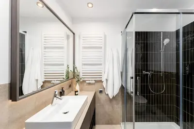 a bathroom with a sink and a shower at Wielopole Top Floor Apartments by Hostly in Kraków