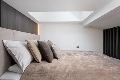 a bedroom with a large bed with pillows on it at Wielopole Top Floor Apartments by Hostly in Kraków