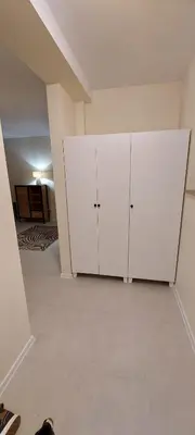 a room with two white cabinets in a room at Secret Room Niepołomice in Niepołomice