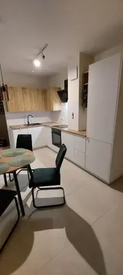 a kitchen with a table and chairs in a room at Secret Room Niepołomice in Niepołomice