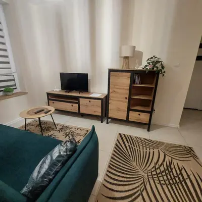 a living room with a couch and a table at Secret Room Niepołomice in Niepołomice