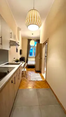 a kitchen with a sink and a refrigerator at City Center Studio in Kraków