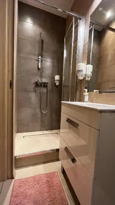 a bathroom with a shower with a glass door at City Center Studio in Kraków
