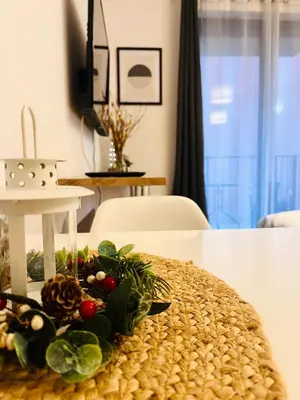 a small kitchen with a sink and red cabinets at Cozy apartment railway station in Kraków