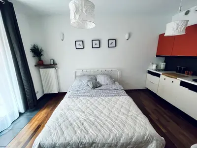 a bathroom with a shower with towels on a shelf at Cozy apartment railway station in Kraków