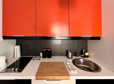 a small kitchen with a bed and a sink at Cozy apartment railway station in Kraków