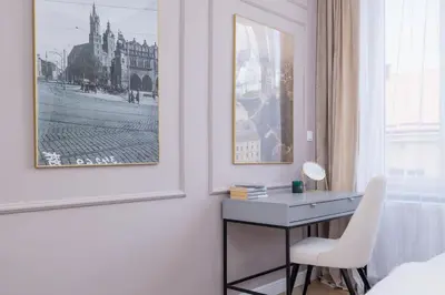a bedroom with a desk and a picture on the wall at Starowiślna Elegant Apartment with Air Conditioning Kazimierz Cracow by Renters Prestige in Kraków