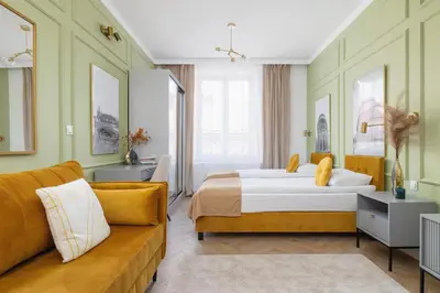a hotel room with a bed and a couch at Starowiślna Elegant Apartment with Air Conditioning Kazimierz Cracow by Renters Prestige in Kraków