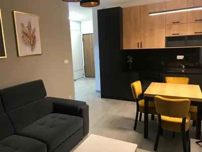 a living room with a couch and a table at Apartament ZARA Self Check In in Kraków