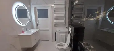 a bathroom with a toilet and a sink and a mirror at Apartament ZARA Self Check In in Kraków