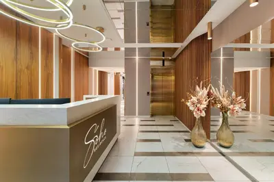 a lobby with two vases with flowers in it at Soho Residence Kazimierz by Downtown Apartments in Kraków