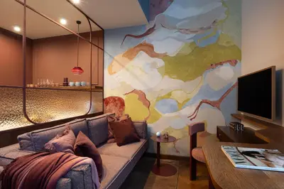 a living room with a couch and a painting on the wall at Soho Residence Kazimierz by Downtown Apartments in Kraków