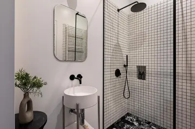 a white bathroom with a sink and a shower at Soho Residence Kazimierz by Downtown Apartments in Kraków