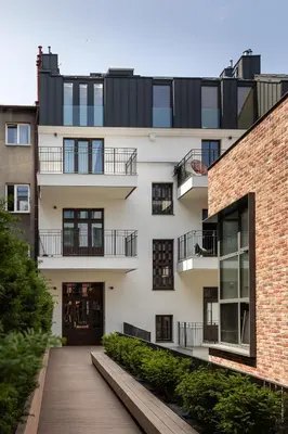 an apartment building with a walkway in front of it at Soho Residence Kazimierz by Downtown Apartments in Kraków