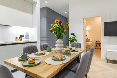 a bathroom with a shower and a toilet and a sink at White Magnolia 4 Bedroom Premium and Parking in Kraków