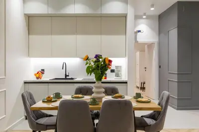 a kitchen and dining room with a table and chairs at White Magnolia 4 Bedroom Premium and Parking in Kraków