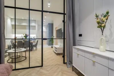 a living room with a table and a dining room at White Magnolia 4 Bedroom Premium and Parking in Kraków