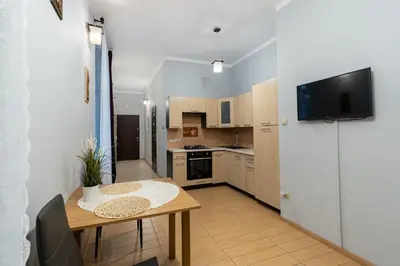 a small kitchen with a table and a television at Wawel neighborhood in Kraków