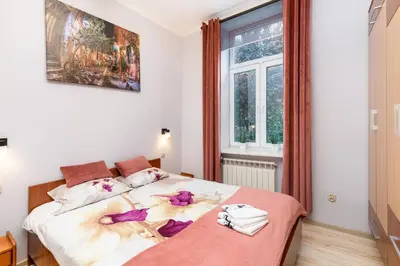 a bedroom with a bed and a window at Wawel neighborhood in Kraków