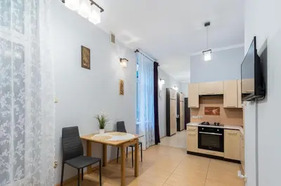 a kitchen with a table and a dining room at Wawel neighborhood in Kraków