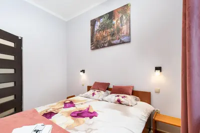 a bedroom with a bed with flowers on it at Wawel neighborhood in Kraków