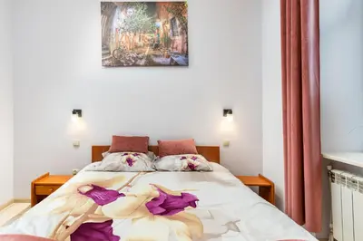 a bedroom with a bed with flowers on it at Wawel neighborhood in Kraków