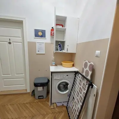 a small laundry room with a washing machine in it at Nowy Kleparz 3 in Kraków