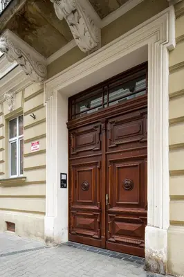 a bedroom with a bed and a tv and a mirror at Verde 2-room in the center in Kraków