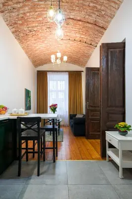 a kitchen and dining room with a table and chairs at Verde 2-room in the center in Kraków