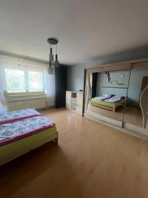 a bedroom with two beds and a large mirror at Polanki u Anki in Zawoja