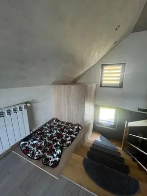 a room with a bed in the middle of a attic at Polanki u Anki in Zawoja