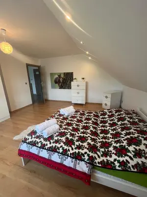 a bedroom with a large bed with a floral blanket at Polanki u Anki in Zawoja