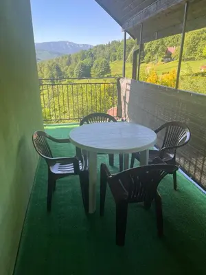 a table and chairs on a balcony with a table and chairs at Polanki u Anki in Zawoja