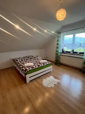 a bedroom with a bed in the middle of a room at Polanki u Anki in Zawoja
