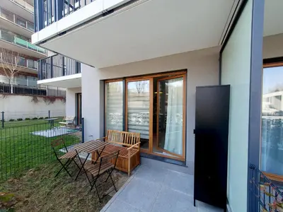 a patio with a table and chairs on a balcony at Apartamenty przy Malborskiej in Kraków
