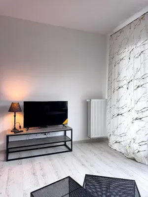 a living room with a flat screen tv on a wall at Apartamenty przy Malborskiej in Kraków