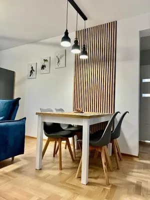 a dining room with a table and chairs at Blue Zone Apartment with FREE Parking, Balcony and Garden in Kraków