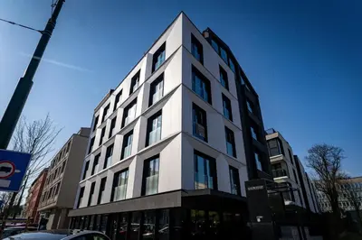 a tall white building on a city street at luxusowy apartament w centrum Krakowa in Kraków