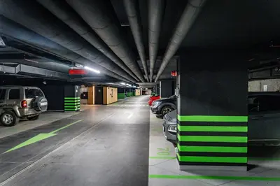a parking garage with cars parked in it at luxusowy apartament w centrum Krakowa in Kraków